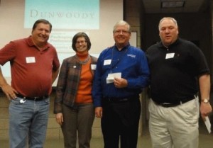 Mike Beck, Karen Conroy, Greg Johnson present check to Dunwoody's Frank Claude